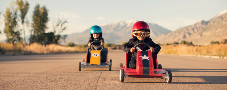 Two kids in race cars 