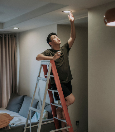 man fixing light