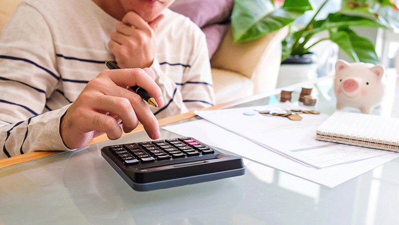 Women with calculator budgeting