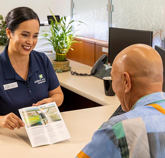 ASB banker reviewing pamphlet with customer