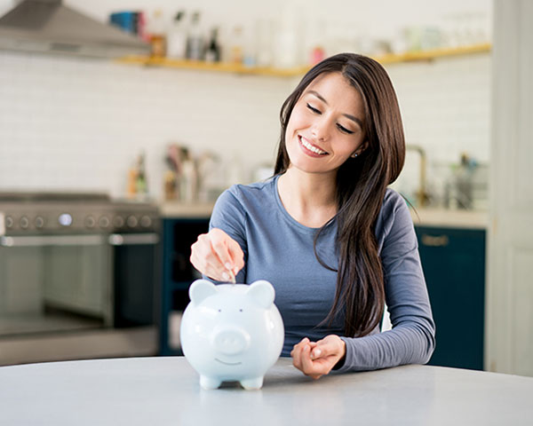Female putting money in piggybank