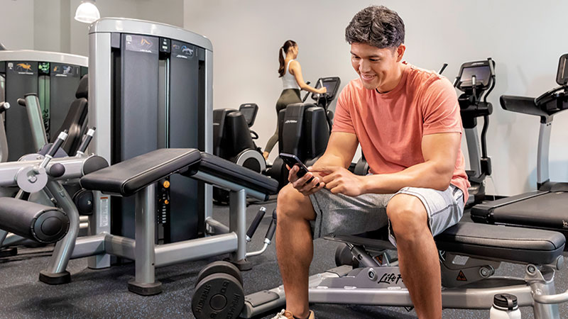 Male at the gym on phone