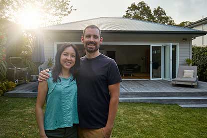 Couple in front of home